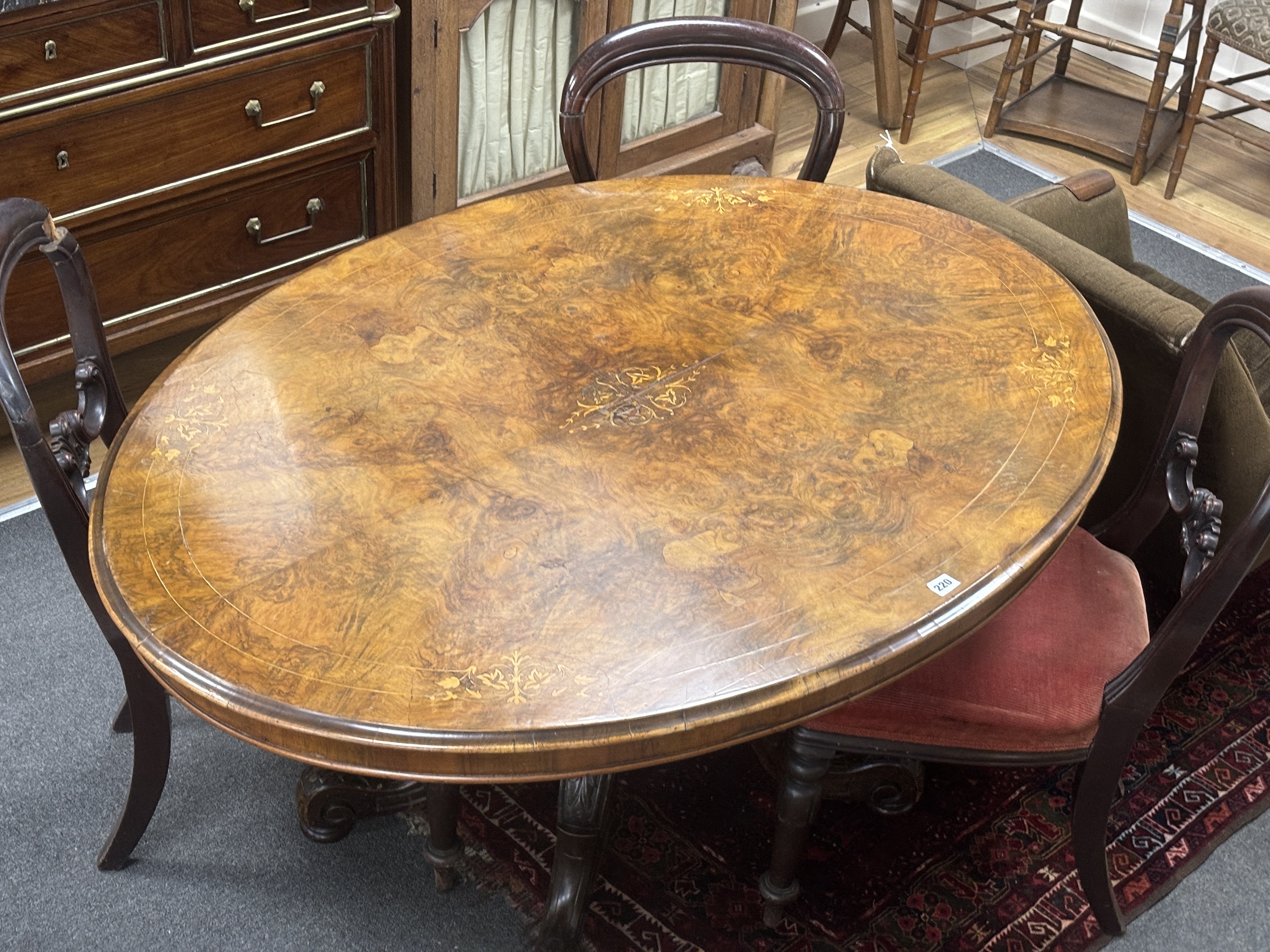 A Victorian inlaid burr walnut oval tilt top loo table, width 134cm, depth 102cm, height 71cm